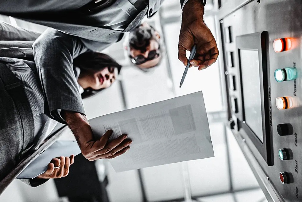 Two physical security professionals looking at a paper document